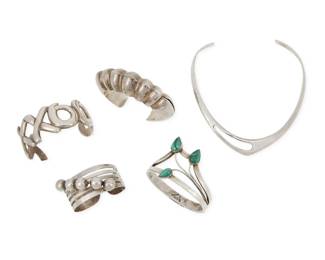 283 A group of Mexican-style silver and set stone jewelry Mid/late 20th century Four variously marked for sterling and three for Mexico; further variously marked: TE-20 / TB-88 / TH-01 / S [within a triangle] / JH Five works comprising a tapered sterling silver torque collar necklace, along with four silver cuffs including an XXXOOO openwork sterling silver cuff, a shaped sterling bangle with curved branched leaf motifs with set malachite, a modernist style sterling silver repoussé cuff, and a multiwire cuff with applied silver balls and stampwork to terminals 5 pieces Collar: 12" L x 0.75" H; Largest cuff: 7" total inner C x 1.25" H; Smallest cuff: 5.875" total inner C x 1" H 225.2 grams gross Estimate: $300 - $500