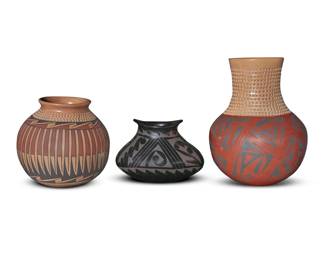 123 Three Mata Ortiz pottery jars Three works:  Socorro Reyes (b. 20th century) A blackware pottery jar, late 20th century Incised to underside: Socorro Reyes With oval form, shaped rim, and black on black geometric motifs 4.625" H x 6.25" W x 4" D  Tomasa Mora (b. 20th century) A polychrome pottery olla, late 20th century Incised to underside: Tomasa Mora With corrugated shoulder above black and red banded feather motifs on a cream slip ground 5.75" H x 6" Dia.  Octavia Silveira (b. 1977) A polychrome pottery olla, late 20th century Incised to underside: TAVO SILVEIRA With corrugated neck and shoulder above black and red banded geometric motifs 8.625" H x 6.375" Dia.  3 pieces Estimate: $100 - $200