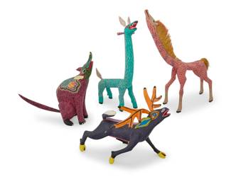 239 Four Mexican polychrome wood alebrijes Late 20th/early 21st century; Oaxaca, Mexico Antlered signed: ELEAZAR / MORALES; taller giraffe inscribed: TRIBUS. MIXES [Noel and Neftalí Martínez Villanueva] / AYUTLA. OAXACA. MEXICO Comprising four vibrantly painted folk art spirit figures including two giraffe, one with fibrous mane and tail 4 pieces Taller giraffe: 15" H x 12" W x 3.5" D; Shortest with antlers: 8.125" H x 10" W x 10.5" D Estimate: $200 - $400