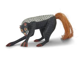 233 Manuel Jiménez Ramírez (1919-2005, Mexican) & Sons A polychrome carved copal wood skunk alebrije, late 20th century; Oaxaca, Mexico Signed: AUTOR / MANUEL JIMENEZ / ANGELICO JIMENEZ / ISAIAS JIMENEZ Created with sons Angélico Jiménez Hernández (b. 1954, Mexican) and Isaías Jiménez Hernández (b. 1961, Mexican), the zorrillo (skunk) with fibrous tail, on a later acrylic plinth Without tail: 6.5" H x 10.5" W x 8.75" D; Acrylic: 0.875" H x 13" W x 6.125" D Estimate: $300 - $500