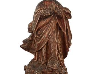 14 A Spanish Colonial polychrome carved wood santo bulto 19th century The painted and giltwood figure with intricate designs to robe above a base with putti masks in relief 16" H x 9" W x 6.75" D Estimate: $400 - $600