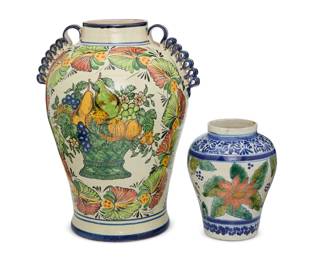 180 Two Mexican Talavera pottery jars 20th century; Puebla, Mexico Each unmarked Comprising a large baluster-form jar with opposed scrunched ribbon handles, one side featuring a painted polychrome basket with fruits, the other side depicting two birds and floral motifs, and a smaller jar with banded Chinese-style blue foliate motifs centering polychrome flowers 2 pieces Larger: 19.5" H x 15" W x 12.5" D; Smaller: 10.375" H x 8.25" Dia. Estimate: $200 - $300