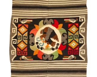 106 A Mexican textile Mid/late 20th century A heavy textile woven in two pieces in black, grey, cream, and multicolored wool featuring a central Mexican coat-of-arms eagle and snake medallion with stepped and hooked motifs with birds to each side and striped banding to ends, seamed down the center 80" H x 62.5" W approximately (excluding fringe) Estimate: $200 - $300