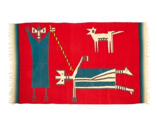 47 A Mexican pictorial sarape Circa 1930 Depicting a standing god-like figure smiting a second figure, while a coyote animal looks on, the textile woven in red, blue, grey, cream and multicolored wool, with yarn fringe to ends 84" H x 51.5" W approximately Estimate: $700 - $900