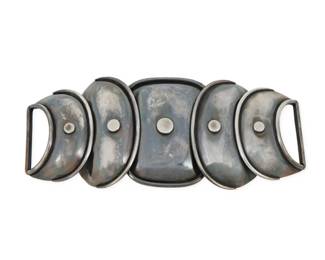 275 Hector Aguilar (1905-1986, Mexican) A Mexican sterling silver 'Armadillo' belt buckle Circa 1943-1948; Taxco, Mexico Stamped: HA / Sterling / Made [small letters] in Mexico A two-piece hook clasp belt buckle of graduated hammered sterling silver concave discs with rivet accents and ridged edges 2.75" H x 6.375" W 141.4 grams gross Estimate: $400 - $600