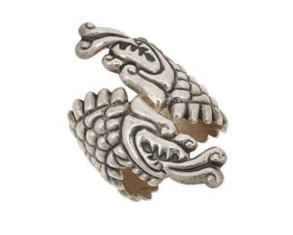 267 A Mexican sterling silver Quetzalcoatl clapper bracelet Late 20th century Stamped: Mexico / Nava / 925 The chunky hinged repoussé silver cuff wrap bracelet with elaborate two-headed Quetzalcoatl feathered serpent motif 7" inner C x 4.5" H 112.5 grams Estimate: $200 - $400