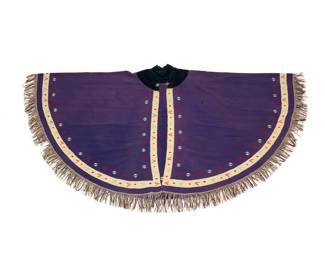 33 A rare Mexican Maximilian Period 'manga' cape Circa 1862-1870 The finely woven purple floss wool circular cape with center back seam, a narrow contrast ivory wool border with blue, red, and pink multicolored floating elements, and a deep navy velvet collar held with two silver fox head clasps, the cape edges trimmed with finely twisted purple and cream wool yarn fringe Center front: 36.5" H; Center back: 39.5" H (excluding fringe); fringe: 4" H; 75.5" Dia. approximately Estimate: $4,000 - $6,000