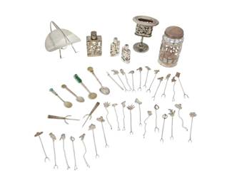293 A group of Mexican silver items Mid-20th century Most marked for maker and/or sterling; three marked for alpaca silver Comprising three Mexican silver overlay perfume bottles, lidded jar, basket, spoon, and a group of 31 cocktail picks, together with an alpaca silver match holder and three spoons 41 pieces Lidded jar: 4.5" H x 2.5" Dia.; Largest perfume: 3.25" H x 2" W x 1" D Total weighable silver: 54. oz. troy approximately Estimate: $200 - $300