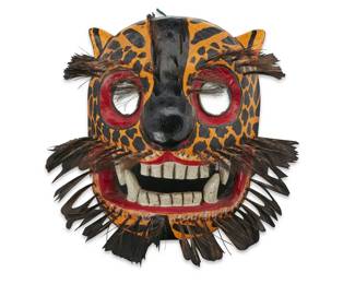 216 A Guatemalan polychrome carved wood jaguar dance mask 20th century With mirror panels set in the eyes, mounted with bundles of horsehair around mouth and eyebrows 15.5" H x 15.5" W x 12.5" D Estimate: $200 - $400