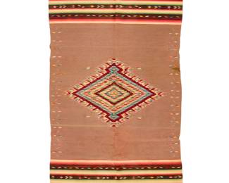 46 A Mexican Saltillo sarape Circa 1880 Finely woven in multicolored wool with an elaborate aggregate-style central serrated diamond with silver metal thread accents, Mexican flag motifs, and with multiple geometric and foliate ombré shaded banded stripe motifs all on a variegated salt and pepper field 86.5" H x 43.5" W approximately Estimate: $700 - $900