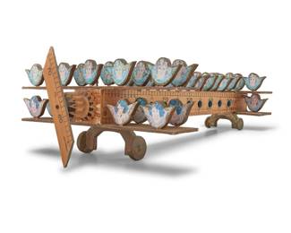 167 Pedro Friedeberg (1936-2026, Mexican) Untitled (An Impassive Biplane) Printed paper and gold leaf on wood, rulers, and mixed media Signed towards front: Pedro Friedeberg Airways; inscribed on tail: Pedro Friedeberg Airways 9.5" H x 28" L x 18.75" W Estimate: $2,000 - $4,000