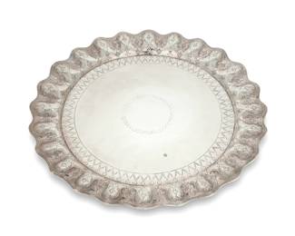 7 A Sanborns sterling silver tray Mid-20th century; Mexico City, Mexico Marked to underside: [Three owls] / Sanborns Mexico / Sterling In the Spanish Colonial style, with piecrust edge chased with bellflower motifs 1" H x 16" Dia. 39 oz. troy approximately Estimate: $1,000 - $1,500