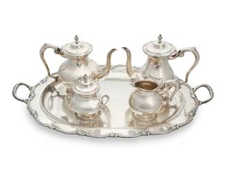 71 A Peruvian sterling silver tea service Mid-20th century Each marked: 925 / INDUSTRIA / PERUANA; tray with inscribed dedication: PARA / DOCTOR LAVANE "SPUTNIK" SANSUM / DE / POLLY "BOWS" WHITEFORD / "UN RECUÉRDO CON AFFECTIONES" Comprising: Coffee pot (9.5" H x 10.25" W x 4.75" D) Teapot (8.75" H x 10.625" W x 5.75" D) Covered sugar bowl (6.125" H x 5.625" W x 4.125" D) Creamer (5.625" H x 6" W x 4.25" D) Tray (2.25" H x 26.5" W x 16.125" D) 5 pieces Total weight: 129.9 gross oz. troy approximately Estimate: $6,000 - $8,000