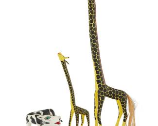 235 Three Mexican polychrome wood alebrijes Late 20th/early 21st century; Oaxaca, Mexico Each giraffe signed and inscribed: Coindo Melchor G / Oaxaca México. The vibrantly painted folk art figures, comprising two giraffes with fibrous tails and a cow 3 pieces Taller giraffe: 35.75" H x 12.5" W x 7.5" D approx.; Cow: 6.875" H x 13.5" W x 9.5" D Estimate: $200 - $400