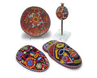 201 Four Mexican Huichol beaded items Mid/late 20th century Comprising two masks, a gourd rattle set in an acrylic stand, and a gourd votive bowl, each intricately decorated with beaded designs 4 pieces Larger mask: 11.5" H x 5.75" W x 3.375" D; Rattle: 10" L x 3.375" Dia.; Bowl: 3.375" H x 8" Dia. Estimate: $200 - $400