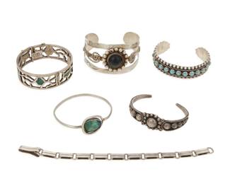 288 Seven Mexican silver and set stone bracelets Five works:  William Spratling (1900-1967) A Sucesores de William Spratling sterling silver link bracelet Circa 1980 or later Stamped with heritage mark for William Spratling; further variously stamped: Taxco / 925 / TS-24 A narrow link bracelet with incised flat bar links and flat hook clasp 7.75" L x 0.375" H  Five Mexican style silver bracelets Mid/late 20th century Four marked for Mexico; three for sterling; further variously marked: Silver / TL-120 / Taxco / JEF / [Eagle 2] A group including three cuffs, each with applied silver wire and ball accents, one with row set blue stones and one with black stone cabochon, as well as an openwork hinged bangle with chipped mosaic inlay, and a narrow bangle with set green stone 7 pieces Largest: 7.25" total inner C x 1.5" H, gap: 1.25"; Smallest: 6.375" total inner C x 0.75" H, gap: 1" 165.8 grams gross Estimate: $250 - $350