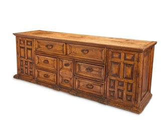 70 A Spanish Colonial Baroque-style carved hardwood buffet 19th century With wrought-iron hardware and six drawers flanked by cabinet doors opening to reveal a single shelf 34.5" H x 96.5" W x 25.75" D Estimate: $800 - $1,200