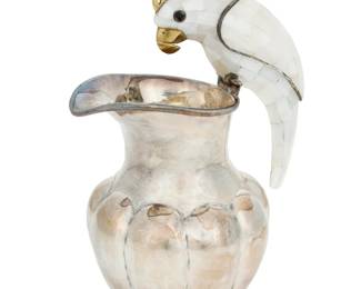 268 A Los Castillo silver-plated figural pitcher Mid-20th century; Taxco, Mexico Marked to underside: Los Castillo / [cipher] / Plateado / Taxco B Mounted with a shell overlay cockatoo handle above a lobed body 8.375" H x 5.75" W x 4.375" D Estimate: $800 - $1,200
