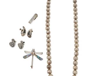 277 A group of Mexican silver jewelry Mid/late 20th century Variously marked for Mexico, Taxco, and sterling; further variously marked: 543 [design no.] / EAC / PA / [Eagle 3] / Beto / Alicia / TN-13 Five works in sterling silver comprising a silver bead necklace, a Spratling-style silver, mixed metal and shell dragonfly brooch, a silver tie clip, and two pairs of silver screwback earrings in swirl and dot motifs 7 pieces Necklace: 25.75" L; Brooch: 2" H x 2" W; Clip: 0.375" H x 1.25" W; Earrings: 1.125" H and 1" H 143.7 grams gross Estimate: $600 - $800