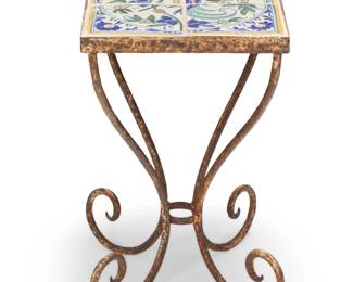 181 A Mexican tile top drink table 20th century The enameled earthenware pottery tiles in a tetraptych depicting a central bird on a floral branch, set into a wrought iron stand raised on four scroll legs 19.25" H x 12.25" W x 12.25" D Estimate: $200 - $400