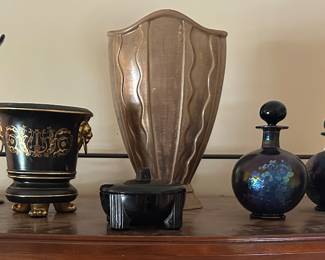 The two bottles on the right, gold vase, black planter and tall black vase are sold.
