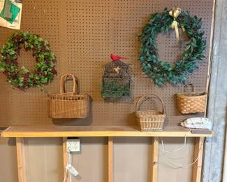 Wall décor including decorative wreaths, wicker baskets, hanging birdcage décor, wall baskets, and seasonal greenery for farmhouse or country decorating.