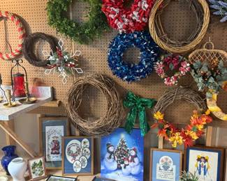 Beautiful collection of decorative wreaths, framed artwork, cross-stitch pieces, seasonal wall décor, holiday prints, and farmhouse home accents.
