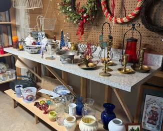 Decorative home accents including brass candlesticks, lanterns, crystal, pottery, cobalt blue glass, decorative bowls, serving pieces, wall baskets, wreaths, and vintage home décor.