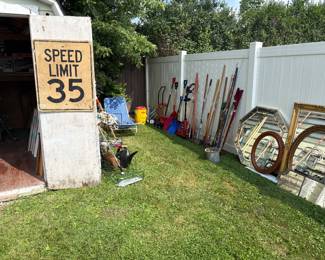 Yard tools and speed limit sign 
