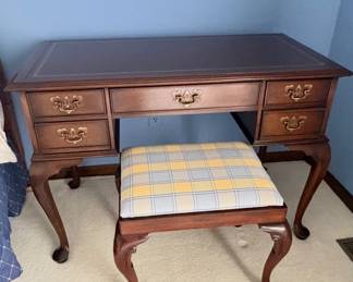 mahogany finish writing desk is in a vintage Queen Anne Style featuring classic cabriole legs.