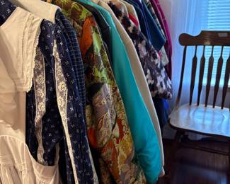 Clothing on racks in bedroom off living area