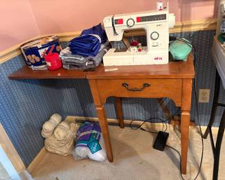 Elma sewing machine in cabinet along with sewing items 