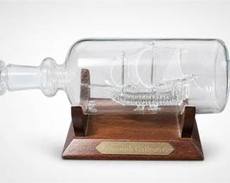 Lot 10049: Glass Spanish Galleon Decanter on Wooden Cradle Stand — current bid $5