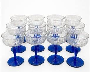 Lot 624: Set of Twelve Iridescent Optic Coupes with Cobalt Stems — current bid $6