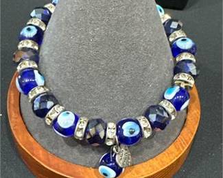 Lot 669: Four Costume Bangles and Evil Eye Bead Bracelet (photo 4)