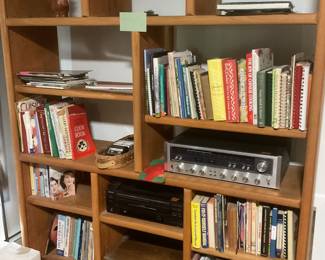 Book shelves with vintage cookbooks and electronics 