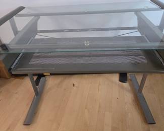 Lot #178 - Modern Glass Top Desk with Metal Frame and Pull Out Storage Shelf - Industrial Style Office Furniture