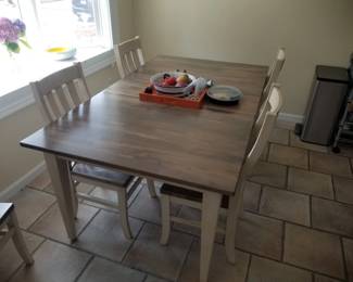 Dining table seats six; includes two table leaves (one shown, one in storage)