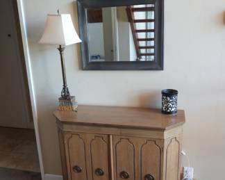 Vintage wood console cabinet. Wall mirror. Table lamp.