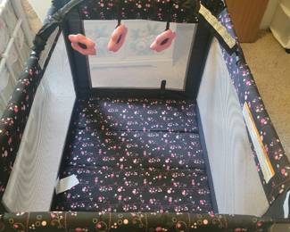 Graco  porta crib.  Includes padded bottom and flower mobile.  L:ike new