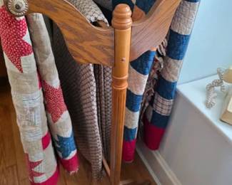 Tall wooden quilt rack and quilts