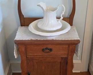 Antique oak washstand with ironstone pitcher and bowl