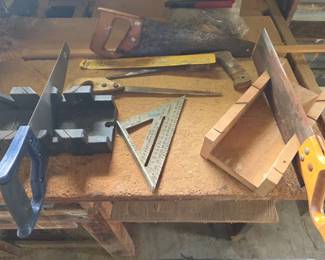 Collection of hand saws with mitre boxes and framing square