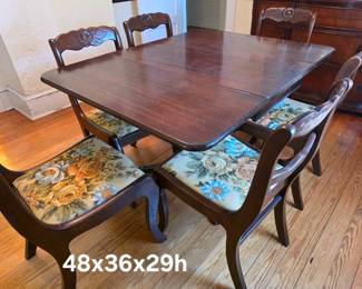 Brandt mahogany drop leaf, single drawer table. Six rose carved chairs with vintage fabric upholstery
