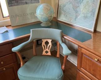 In the upstairs office, there is this comfortable green upholstered chair plus world map, globe and print of Dupage county