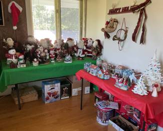 Two full tables of Christmas decorations: 2 ceramic trees, lots of Santa’s. Village houses