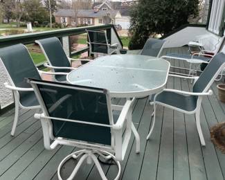Really nice white table with glass top and six chairs….two are swivel