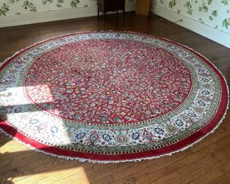 Beautiful round rug in red, blue and white with a 10” border