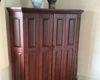 Corner cabinet with double door opening for tv.. measures 65” h x 57” w x 21” d