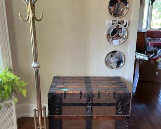 Antique truck, vintage brass hall tree, and hanging Norman Rockwell plates